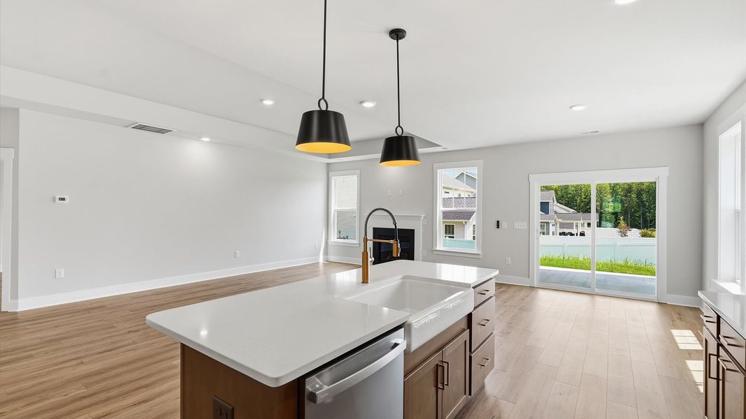 Memorable meals begin in this vibrant kitchen with pendant lighting and a thoughtfully designed island Memorable meals begin in this vibrant kitchen with pendant lighting and a thoughtfully designed island
