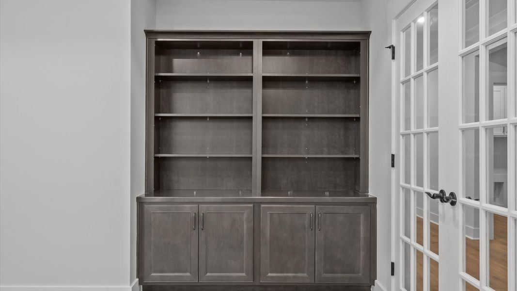 Elegant and flexible French door study with built-in shelves ideal for remote work, reading, or creative space