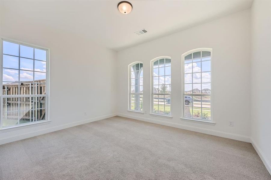 Unfurnished room featuring light carpet