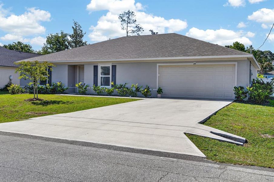 Front exterior of a new home in Palm Coast, Palm Coast, FL, highlighting curb appeal (Image 25).