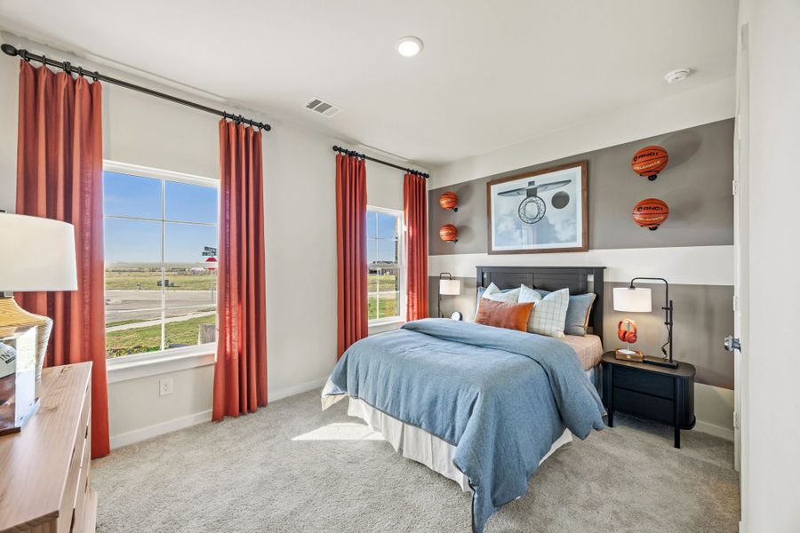 A bedroom with a bed and a window. A bedroom with a bed and a window.