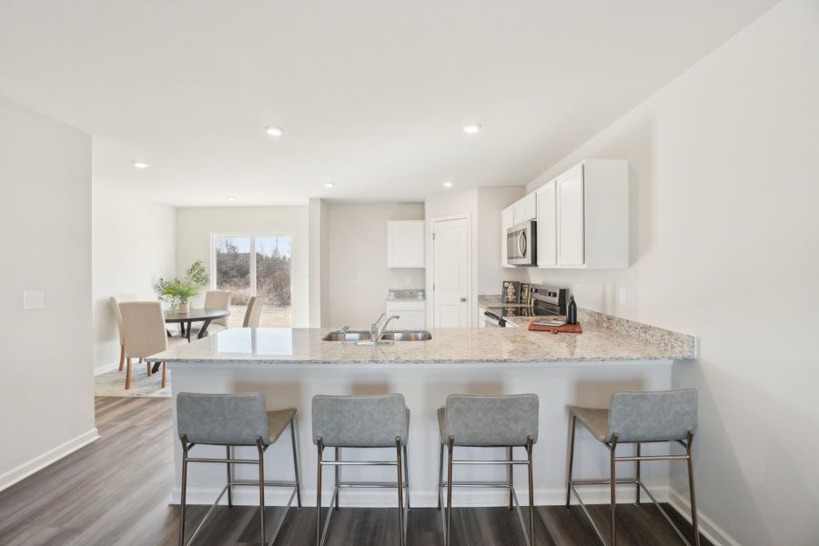 A kitchen with a marble island.