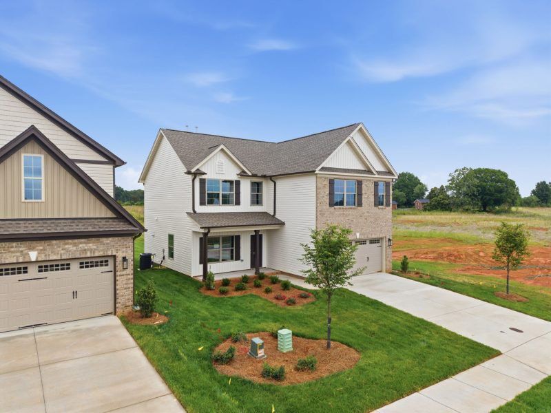 Front exterior of a new home in Sullivans Reserve, Walkertown, NC, highlighting curb appeal (Image 2). Front exterior of a new home in Sullivans Reserve, Walkertown, NC, highlighting curb appeal (Image 2).