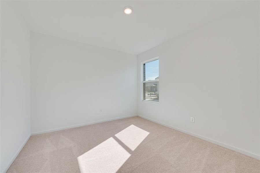 Spare room with light colored carpet