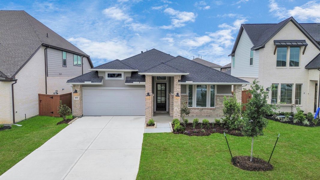 Front exterior of a new home in 50' Traditional Homes at Elyson, Katy, TX, highlighting curb appeal (Image 21). Front exterior of a new home in 50' Traditional Homes at Elyson, Katy, TX, highlighting curb appeal (Image 21).