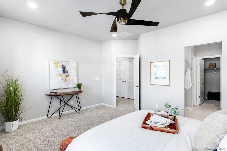 The primary bedroom is very spacious and features an en suite bathroom, walk-in closet, window treatments and an upgraded ceiling fan