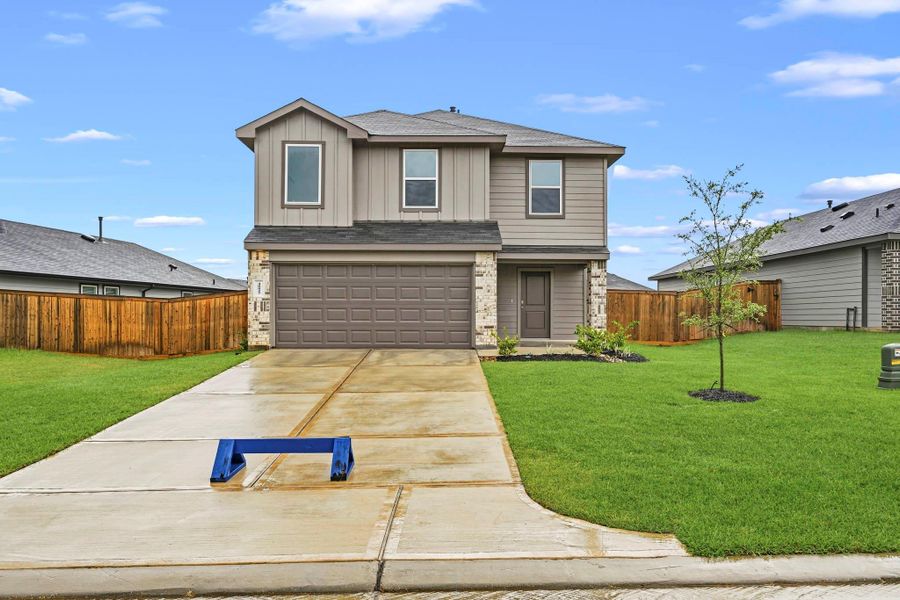 Front exterior of a new home in Mill Creek, Magnolia, TX, highlighting curb appeal (Image 2).