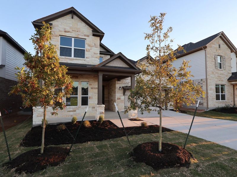 Front exterior of a new home in Edgewood, Leander, TX, highlighting curb appeal (Image 1).