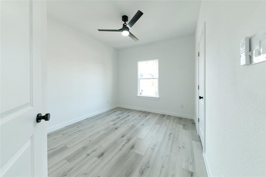 Unfurnished room featuring ceiling fan and light hardwood / wood-style flooring