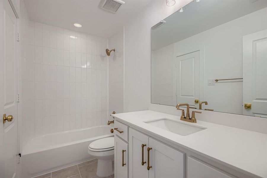 Bathroom featuring shower / washtub combination, vanity, light tile patterned floors, and recessed lighting Bathroom featuring shower / washtub combination, vanity, light tile patterned floors, and recessed lighting