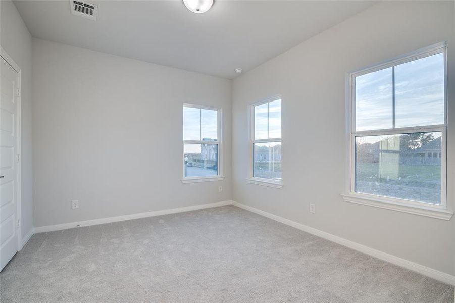 Empty room featuring light colored carpet