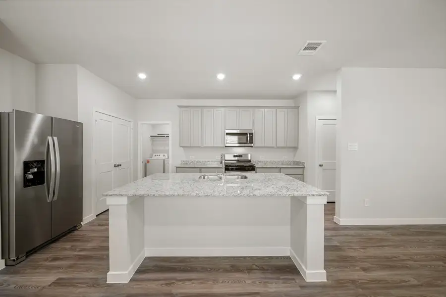 A kitchen with a marble counter.