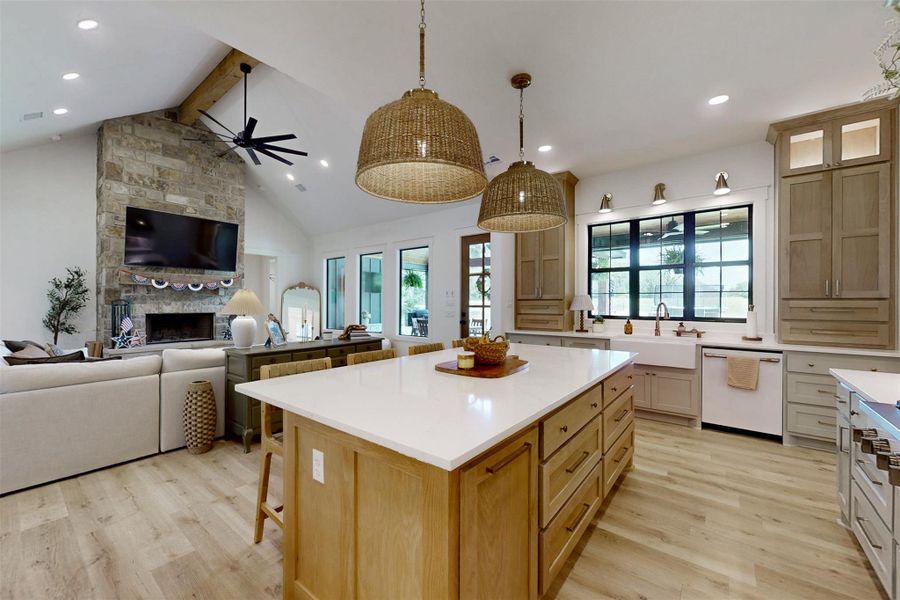 Kitchen with dishwasher, open floor plan, beam ceiling, light wood-type flooring, and light countertops