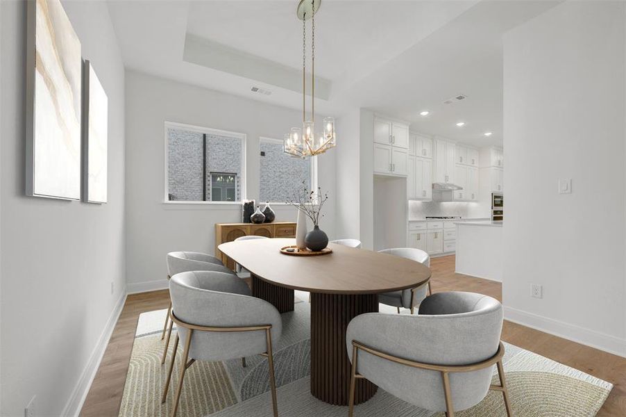 The dining area features light wood flooring, a decorative light fixture, and a large window
