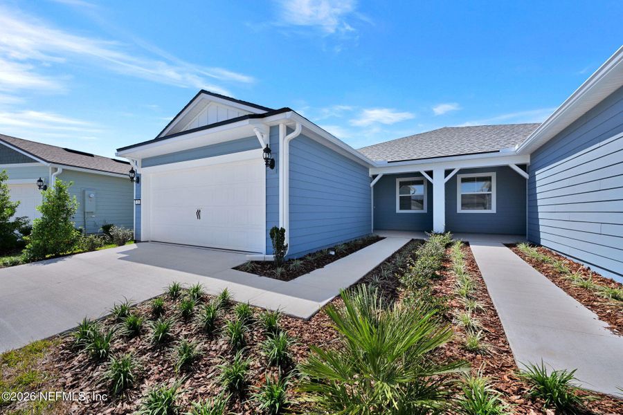 Front exterior of a new home in Del Webb Wildlight, Yulee, FL, highlighting curb appeal (Image 1). Front exterior of a new home in Del Webb Wildlight, Yulee, FL, highlighting curb appeal (Image 1).