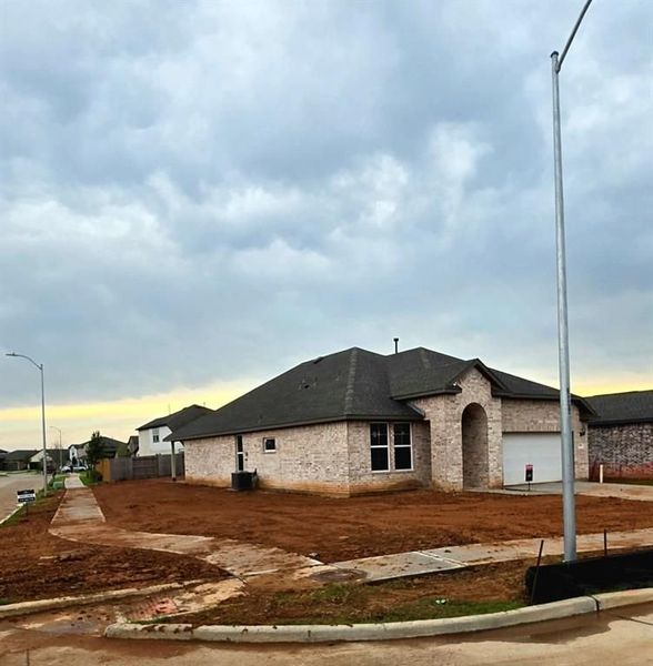 Front exterior of a new home in Sunterra, Katy, TX, highlighting curb appeal (Image 6).