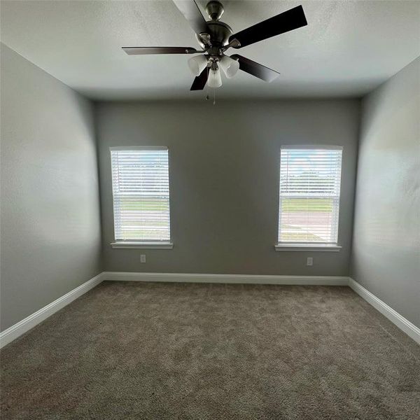 Property back covered porch featuring board and batten siding. Property back covered porch featuring board and batten siding.