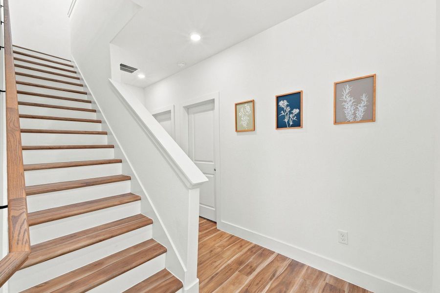 Beautiful wood staircase with modern railing details and a bright, contemporary design. Beautiful wood staircase with modern railing details and a bright, contemporary design.