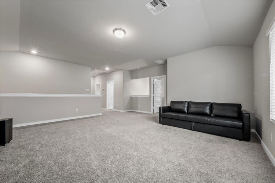 Spacious and light-filled living area designed for comfort and everyday living. The open layout provides ample room for seating and entertainment, with large windows that allow natural light to flow throughout the space.