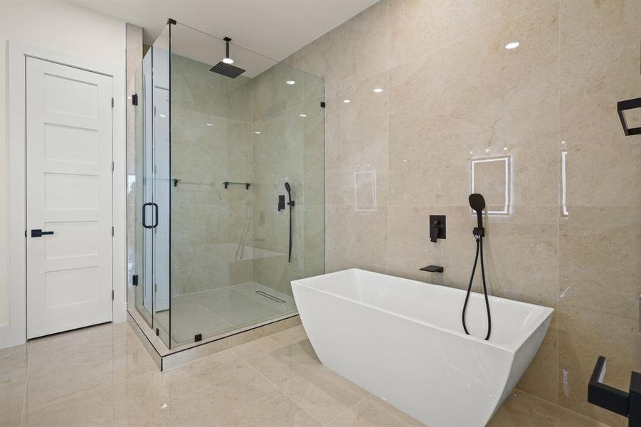 Bathroom with separate shower and tub and tile walls