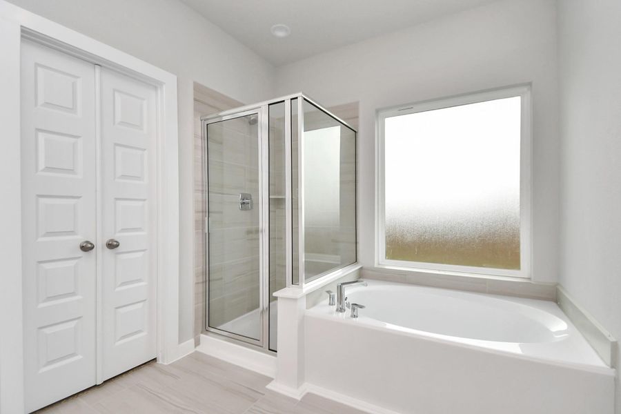 The primary en-suite has a soaking tub to give you that spa experience. The large privacy window allow lots of nature light in the space. Sample photo of completed home with similar floor plan. Actual colors and selections may vary. The primary en-suite has a soaking tub to give you that spa experience. The large privacy window allow lots of nature light in the space. Sample photo of completed home with similar floor plan. Actual colors and selections may vary.