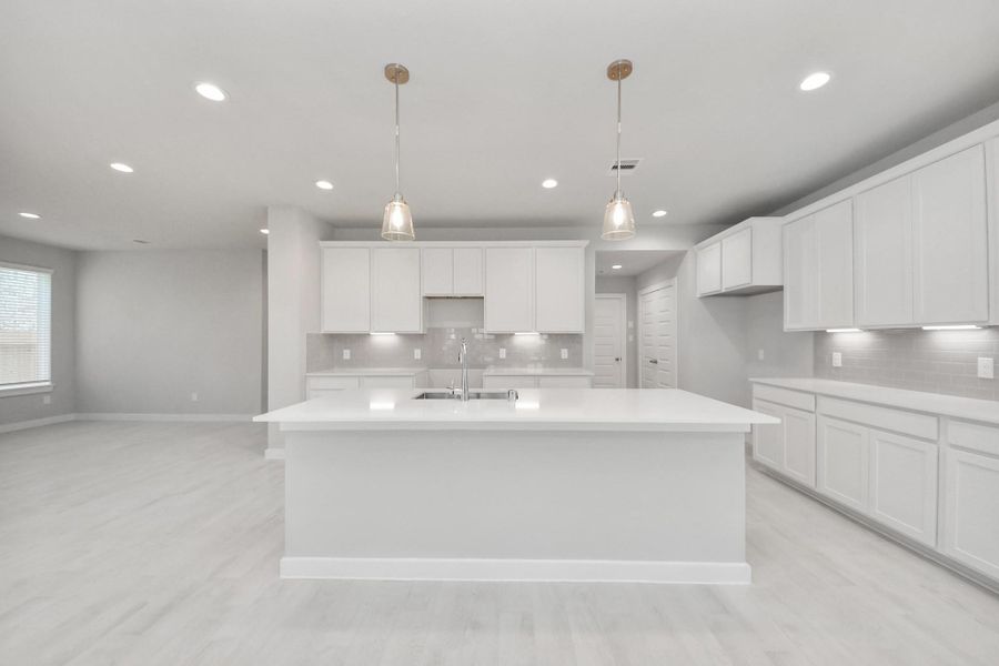 This kitchen is by far any chef’s dream! This spacious kitchen features high ceilings, light stained wood cabinets, granite countertop, SS appliances, modern tile backsplash, recessed lighting, extended counter space, granite kitchen island with double sink, and space for breakfast bar, and a walk-in pantry all overlooking your huge family room. Sample photo of completed home with similar floor plan. Actual colors and selections may vary. This kitchen is by far any chef’s dream! This spacious kitchen features high ceilings, light stained wood cabinets, granite countertop, SS appliances, modern tile backsplash, recessed lighting, extended counter space, granite kitchen island with double sink, and space for breakfast bar, and a walk-in pantry all overlooking your huge family room. Sample photo of completed home with similar floor plan. Actual colors and selections may vary.