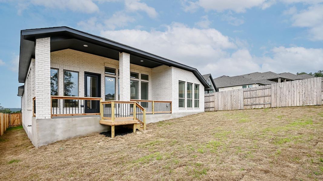 Rear view of property with brick siding