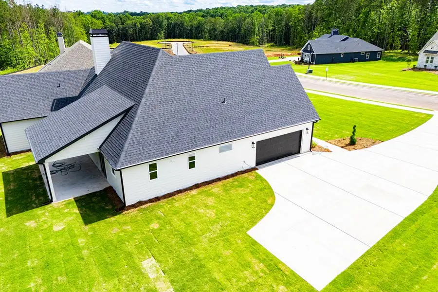 Front exterior of a new home in WOODMONT RESERVE, Roopville, GA, highlighting curb appeal (Image 42).
