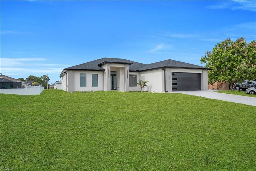 Front exterior of a new home in , Lehigh Acres, FL, highlighting curb appeal (Image 2). Front exterior of a new home in , Lehigh Acres, FL, highlighting curb appeal (Image 2).