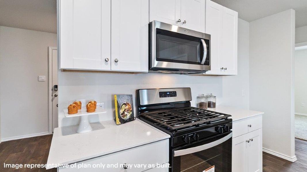 A well-appointed kitchen showcasing a sleek gas range and built-in microwave, complemented by crisp white cabinetry. A well-appointed kitchen showcasing a sleek gas range and built-in microwave, complemented by crisp white cabinetry.