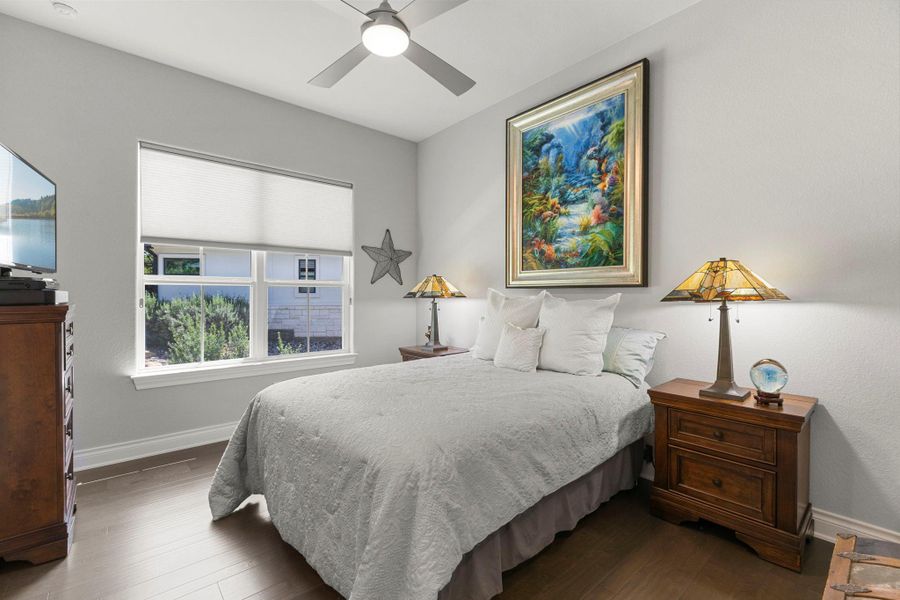 Hardwood floors and an overhead ceiling fan create a comfortable and inviting atmosphere.