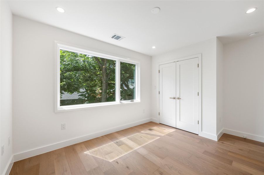 Hardwood floors and generous natural light create an inviting atmosphere in this flexible space. Hardwood floors and generous natural light create an inviting atmosphere in this flexible space.