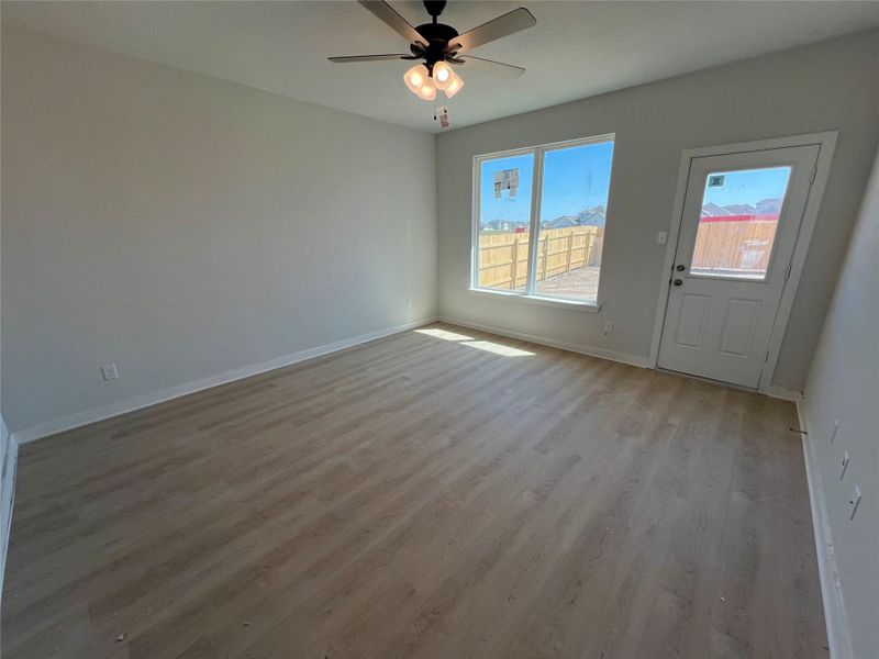 Unfurnished living room featuring light wood-style flooring and a ceiling fan
