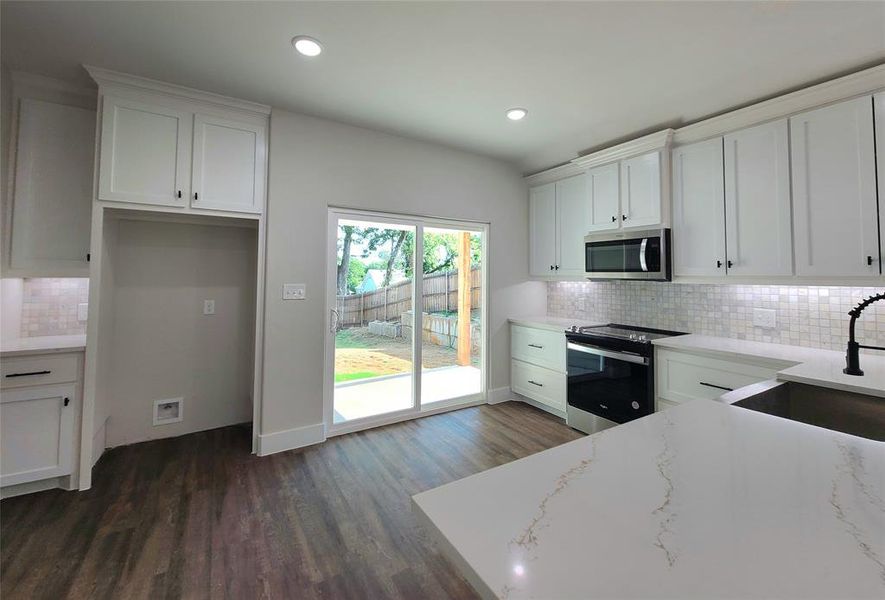 Stainless steel appliances with coffee nook and extra storage.