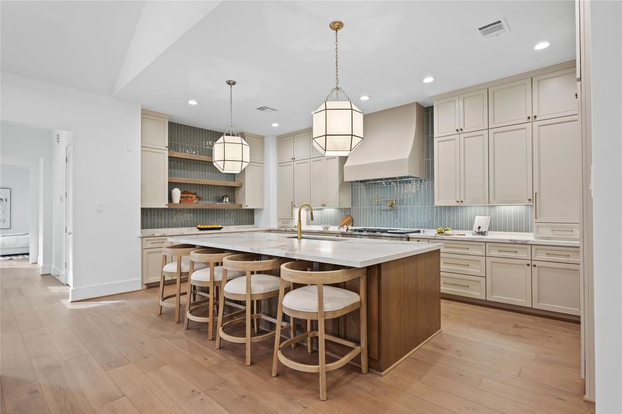 This kitchen features abundant storage with custom made cabinetry crafted by Kent Moore. This kitchen features abundant storage with custom made cabinetry crafted by Kent Moore.