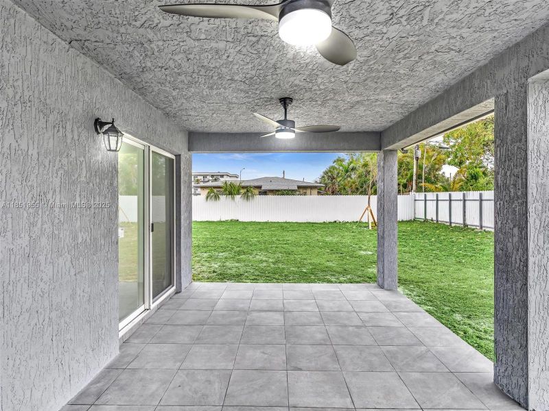 Covered patio area, perfect to set a summer kitchen Covered patio area, perfect to set a summer kitchen