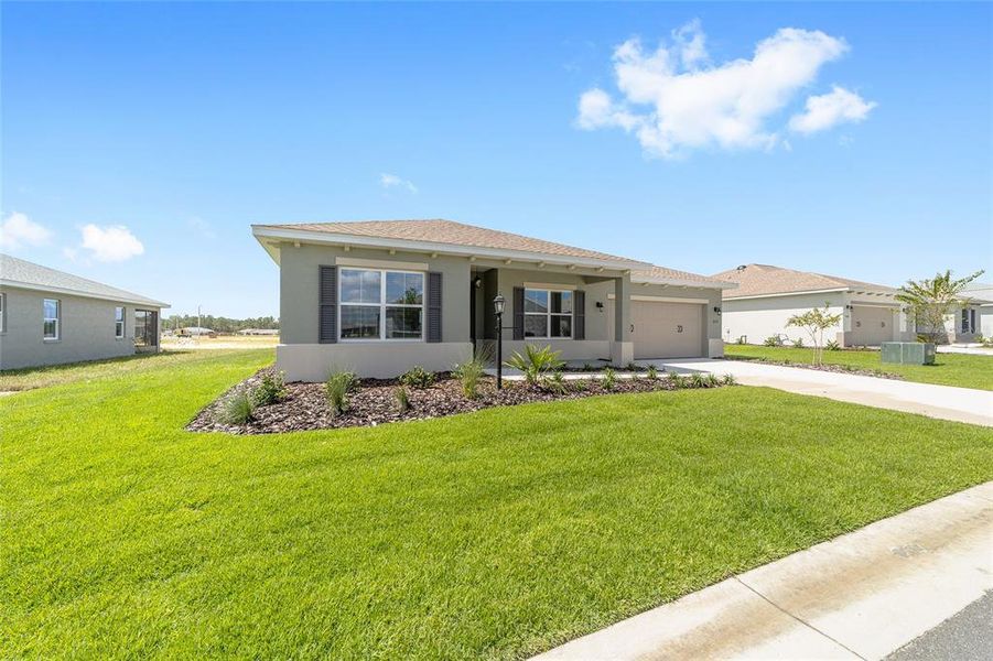 Front exterior of a new home in On Top of the World Communities, Ocala, FL, highlighting curb appeal (Image 17). Front exterior of a new home in On Top of the World Communities, Ocala, FL, highlighting curb appeal (Image 17).