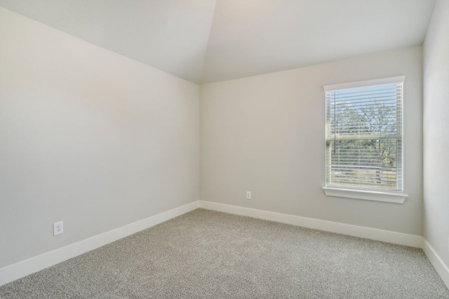 Guest bedroom in the Cedar floorplan at a Meritage Homes community.