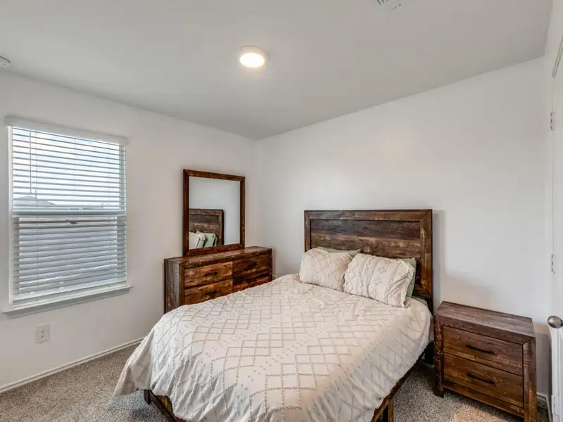 Bedroom with carpet flooring and baseboards