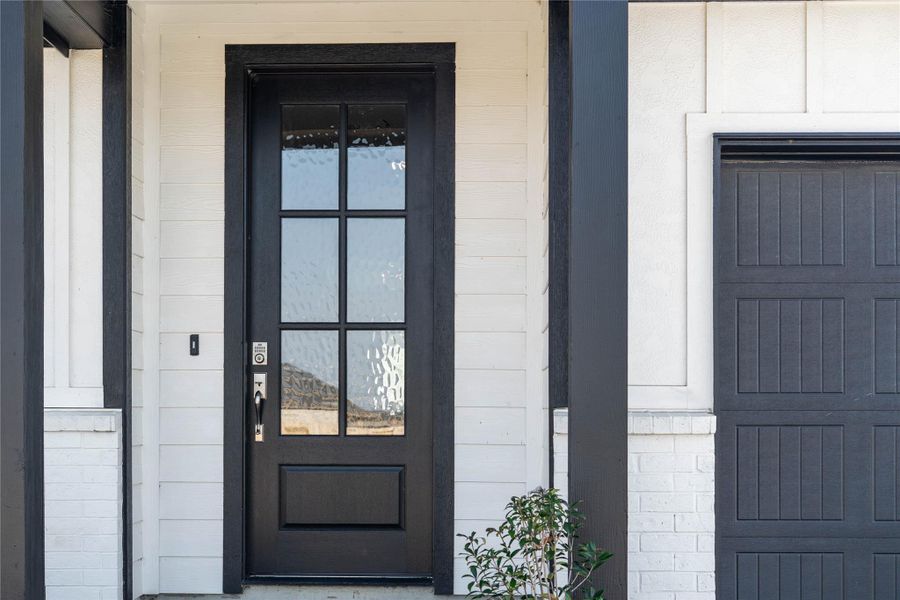 This home is modern elegance with a timeless brick and white siding exterior and high quality entry door.