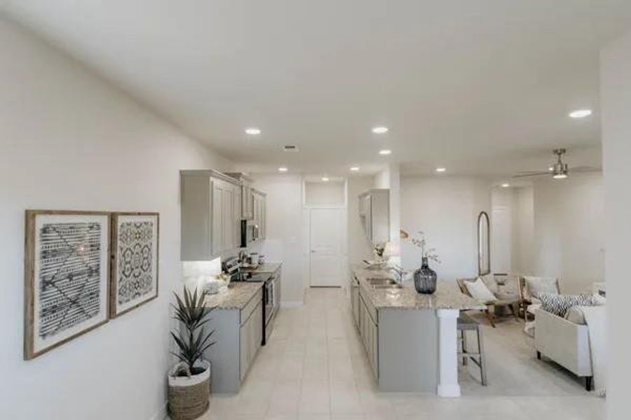 Kitchen featuring a breakfast bar area, gray cabinetry, light stone counters, stainless steel electric stove, and recessed lighting Kitchen featuring a breakfast bar area, gray cabinetry, light stone counters, stainless steel electric stove, and recessed lighting