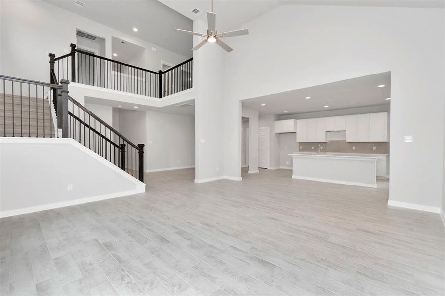 Another view of the family room, and open concept floor plan. Sample photo of completed home with similar floor plan. As-built interior colors and selections may vary