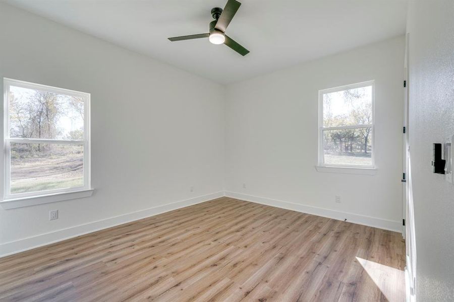 Spare room with light wood-type flooring and ceiling fan