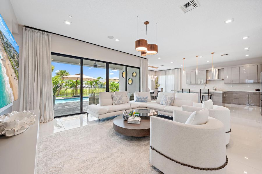 Large great room, gourmet kitchen, and easy access to the covered patio and upgraded heated pool.