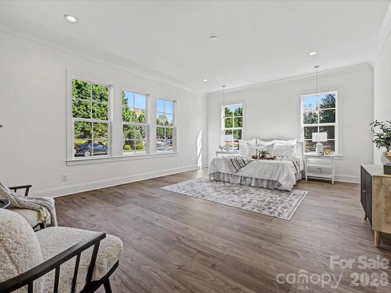 Spacious primary suite filled with natural light, featuring oversized windows, an open layout, and a serene retreat feel.