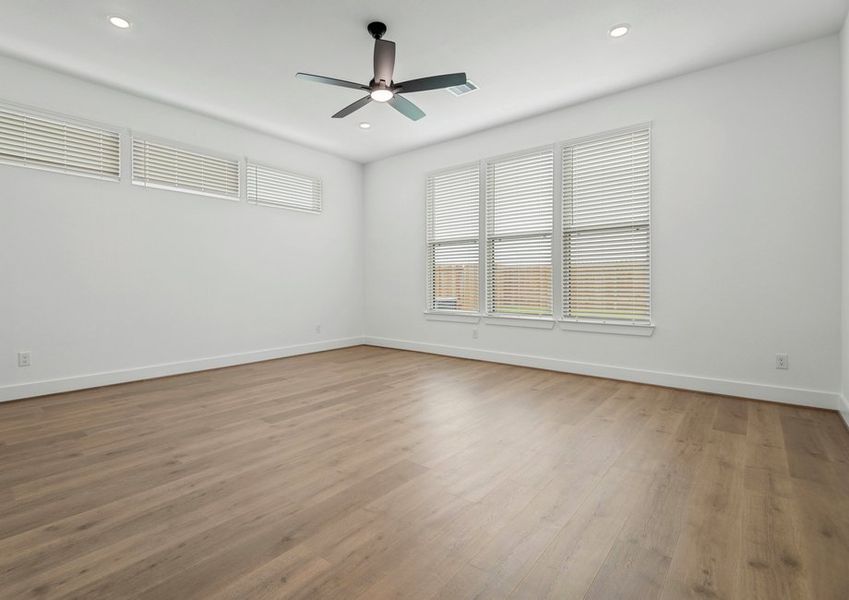 Primary bedroom with large windows. Primary bedroom with large windows.