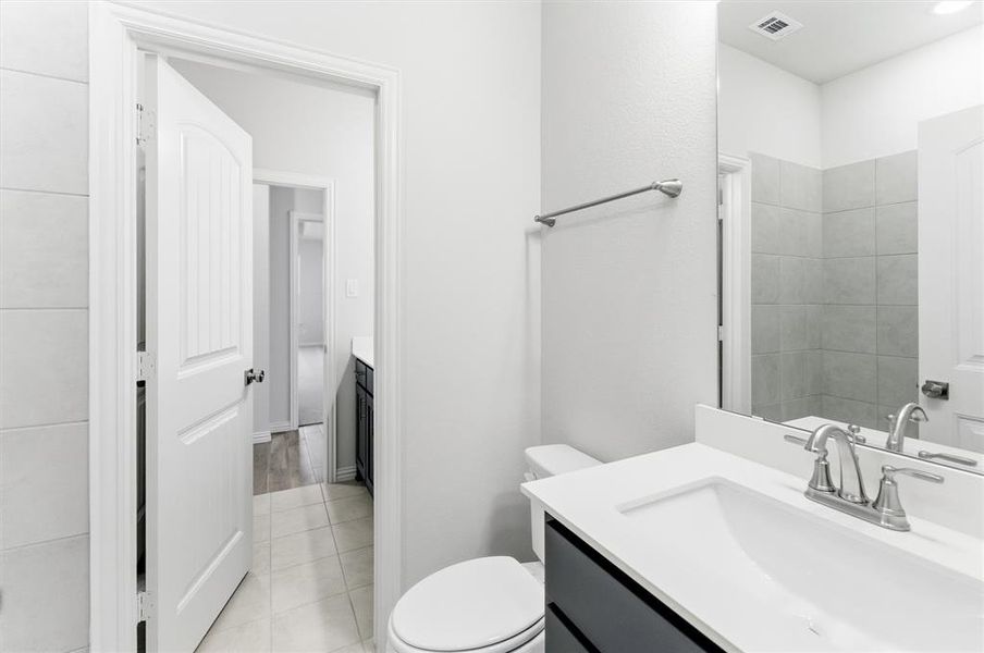 Bathroom with vanity and light tile patterned floors