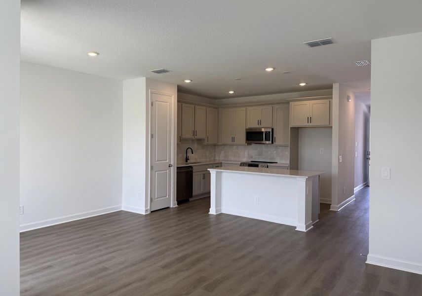 Open concept plan allows for a seamless transition between kitchen, dining and living spaces