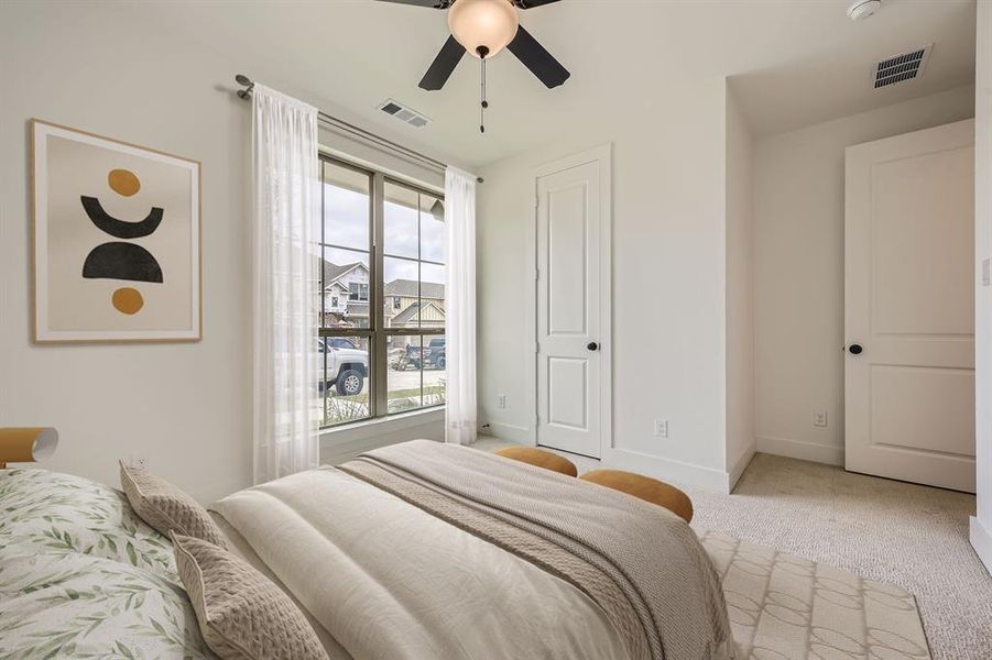 Virtually staged photo- Carpeted bedroom with baseboards and ceiling fan Virtually staged photo- Carpeted bedroom with baseboards and ceiling fan