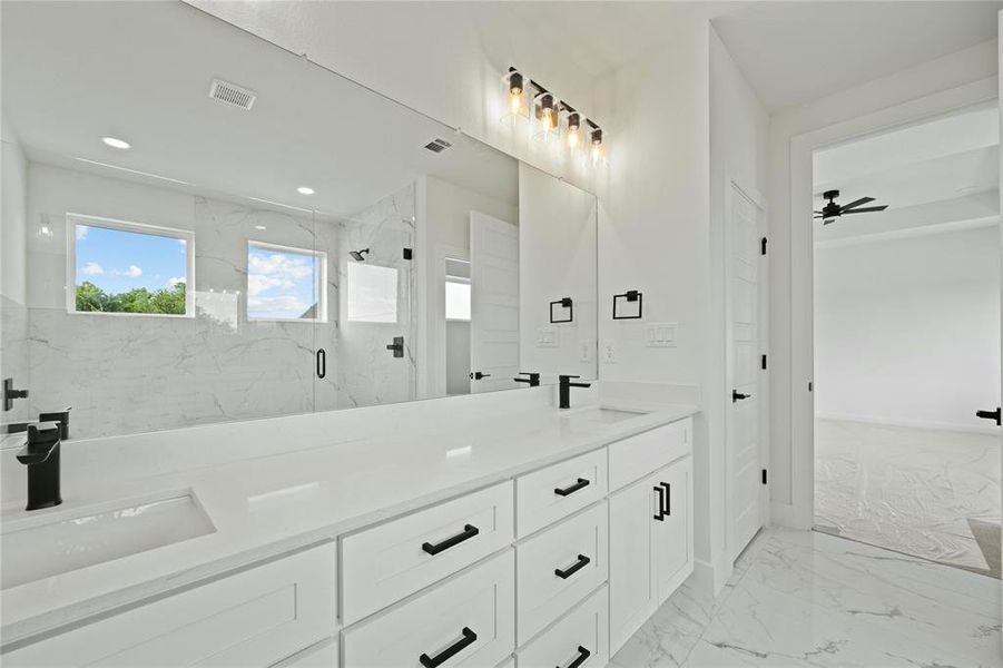 Full bathroom featuring marble finish flooring, double vanity, a marble finish shower, recessed lighting, and a ceiling fan